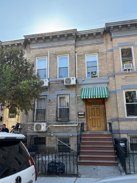 Front of 2 story unit showing entrance and five windows