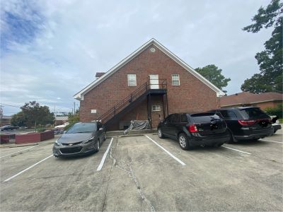 View of back of commercial building with stairway to the second floor