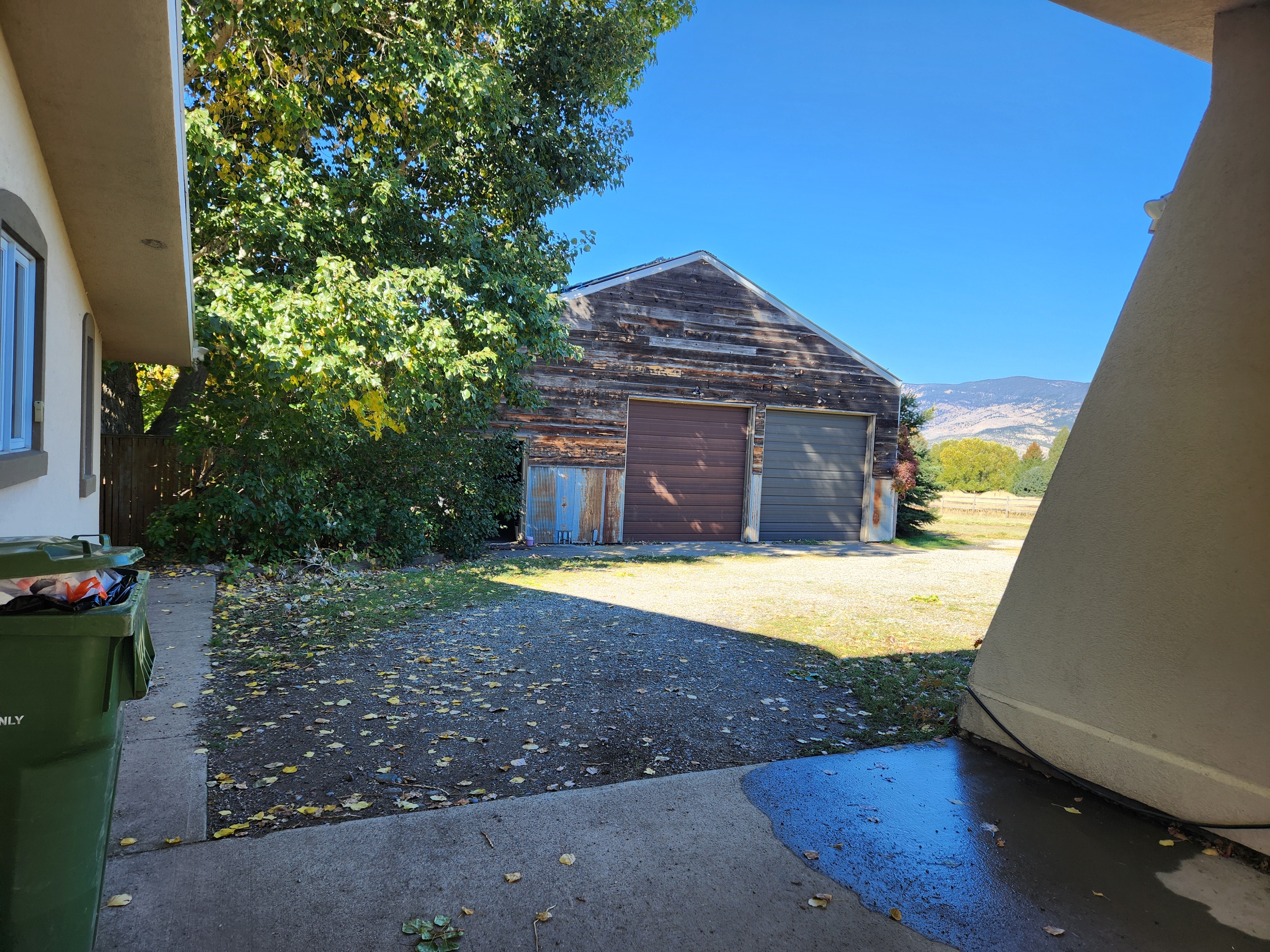 Under carport facing towards garage