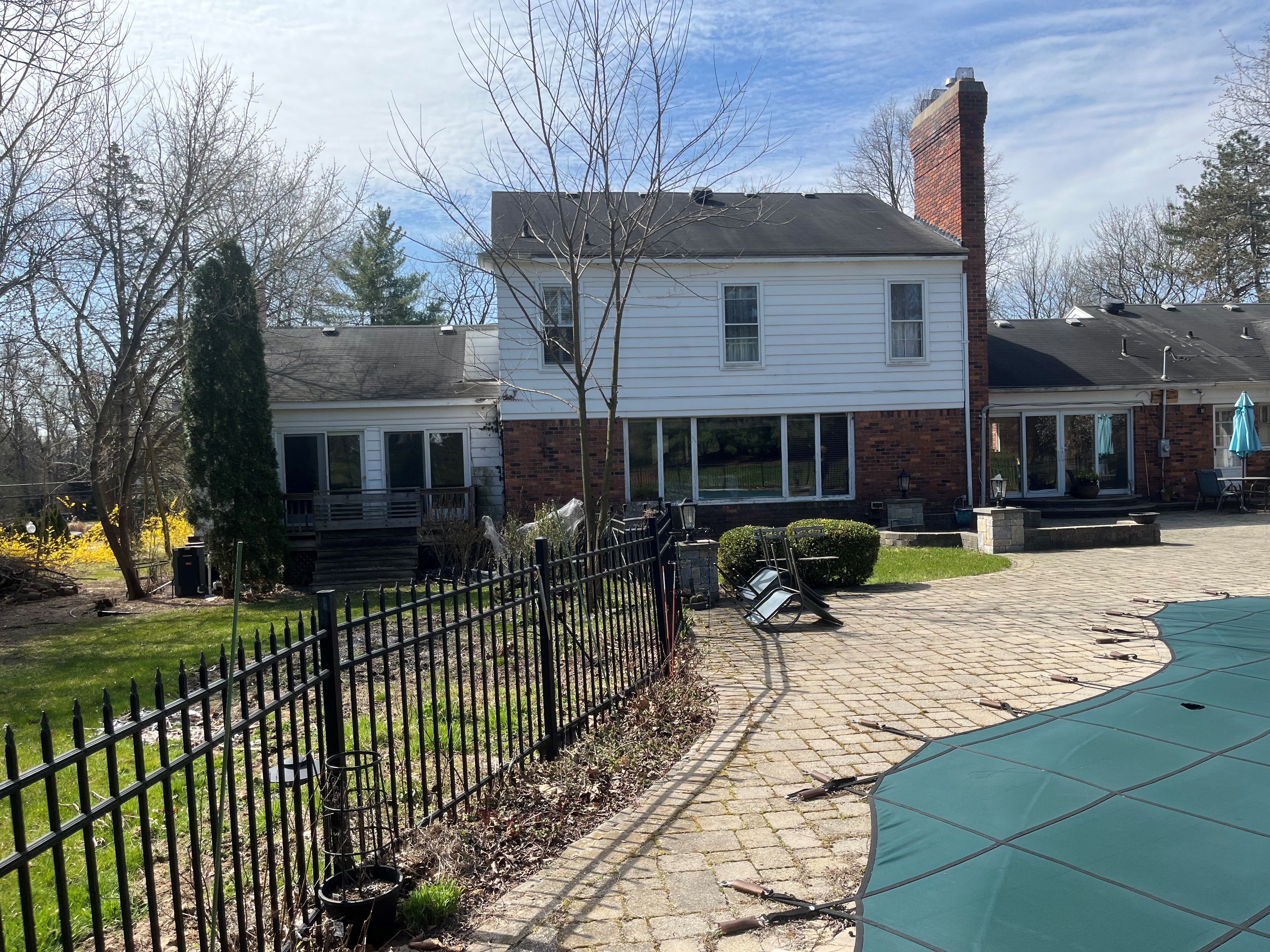 back view of home and part of inground pool