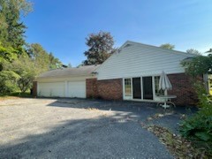 side view of home with 3 car garage