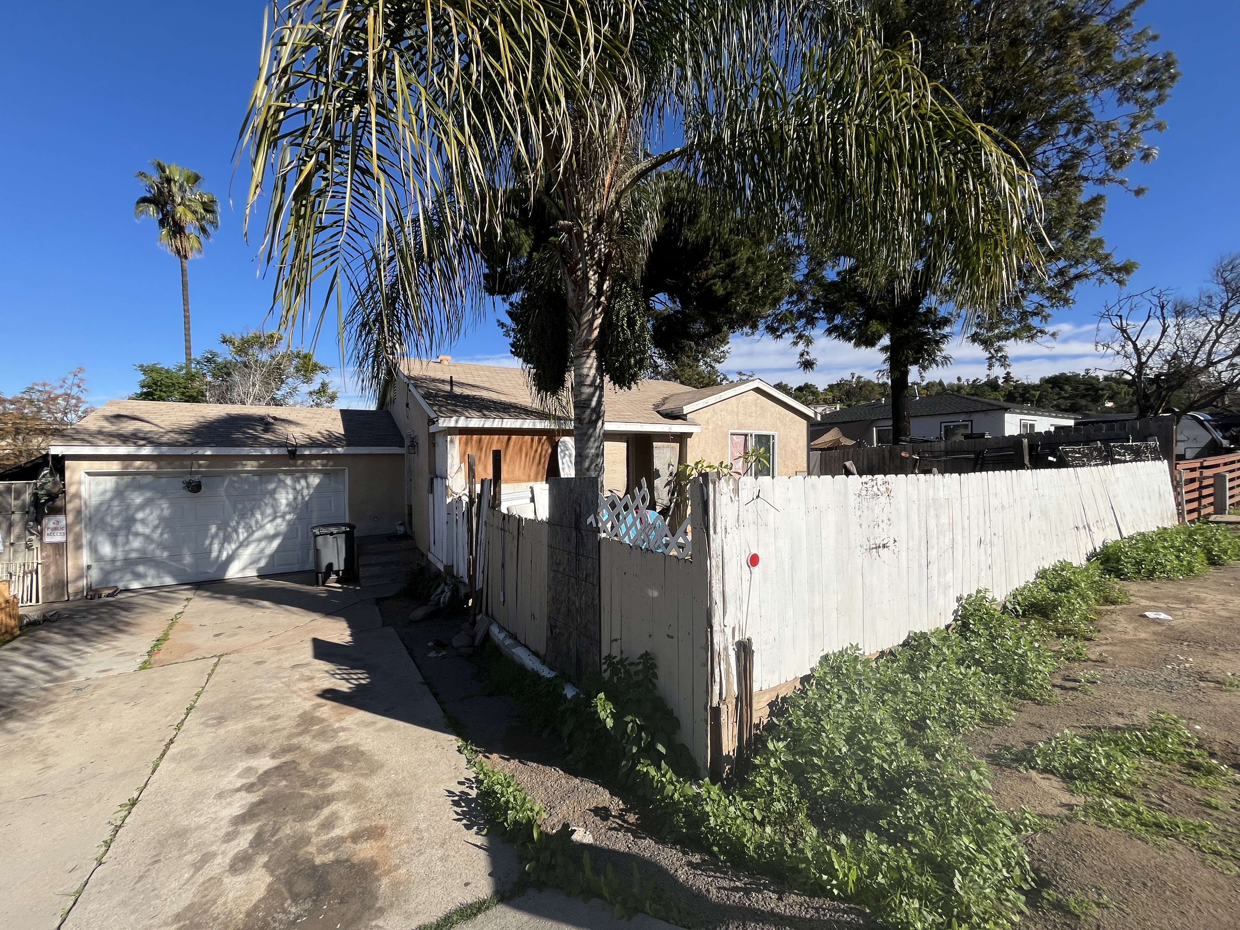 View of front of home and garage from end of driveway.