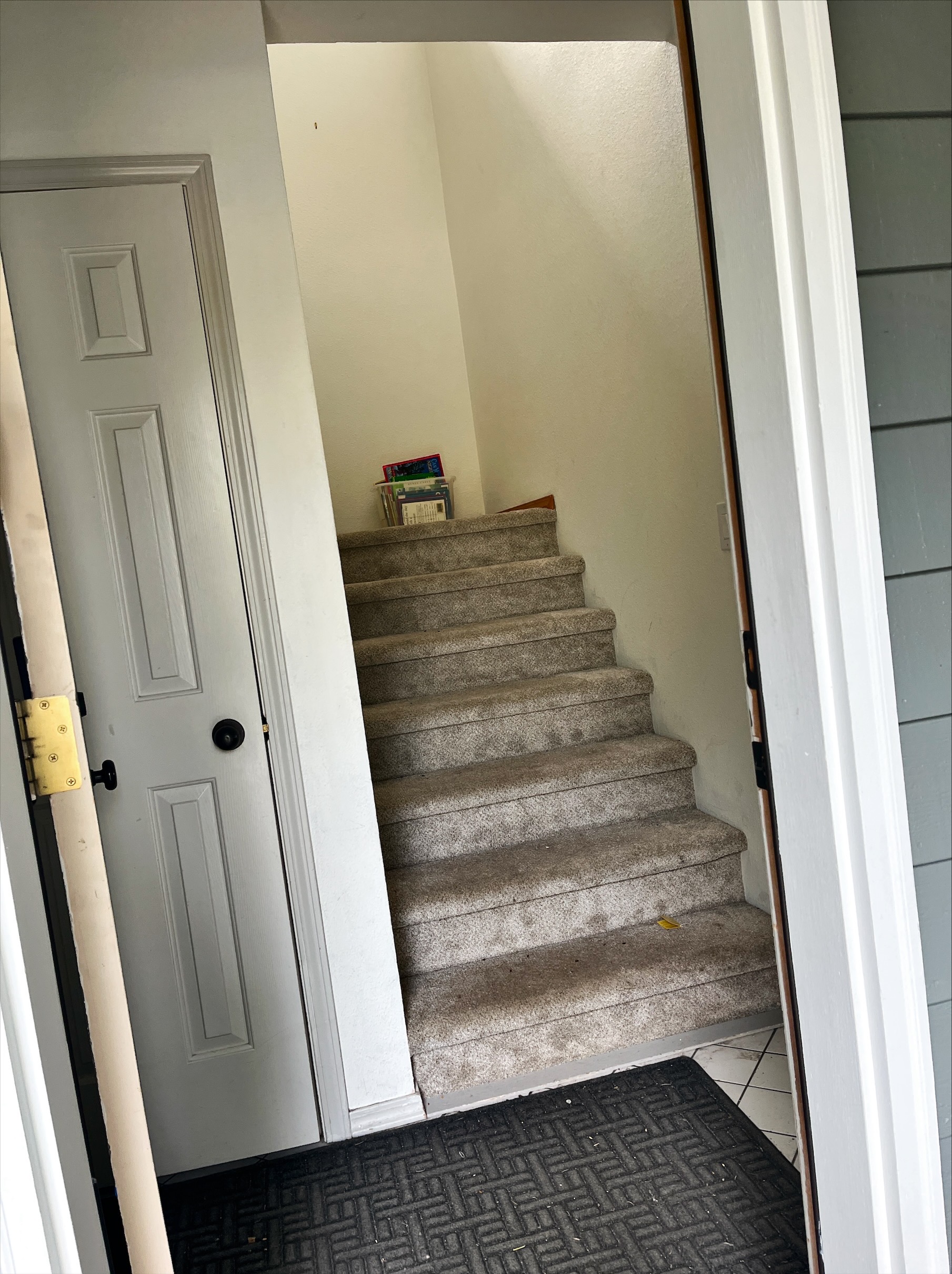 2nd staircase after coming in door next to garage