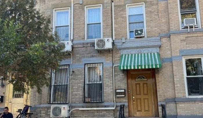 Front of 2 story unit showing entrance and five windows