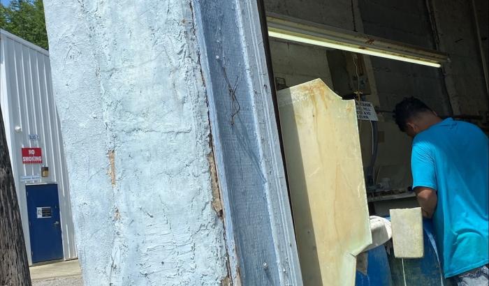 Blue building with garage door open