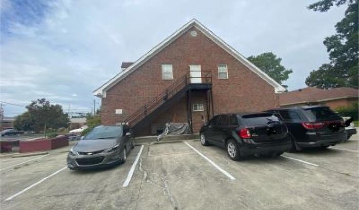 View of back of commercial building with stairway to the second floor