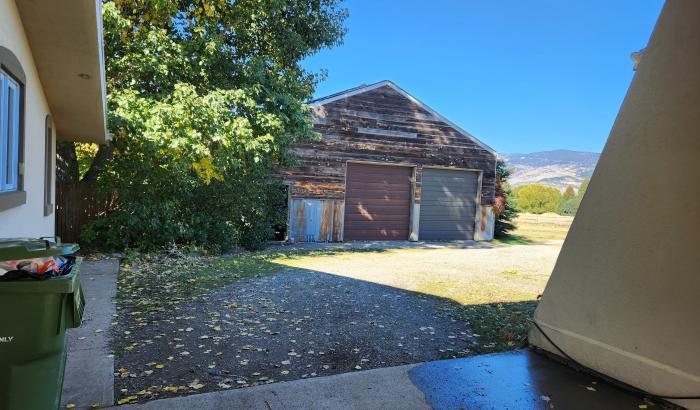 Under carport facing towards garage