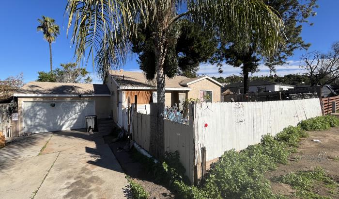 View of front of home and garage from end of driveway.