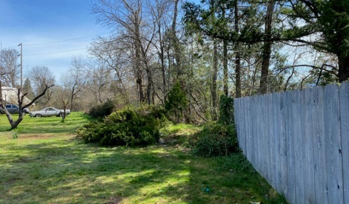 Side view of property with wood fence