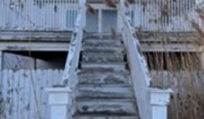 Rear view of the house and stairs that lead to the deck.