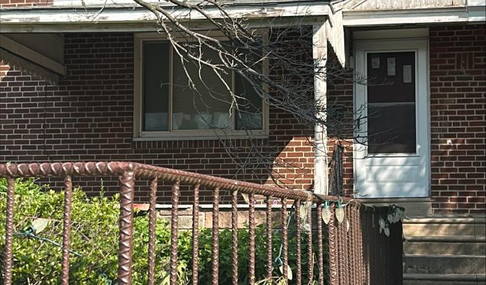 Sidewalk to front door and iron fence around front yard